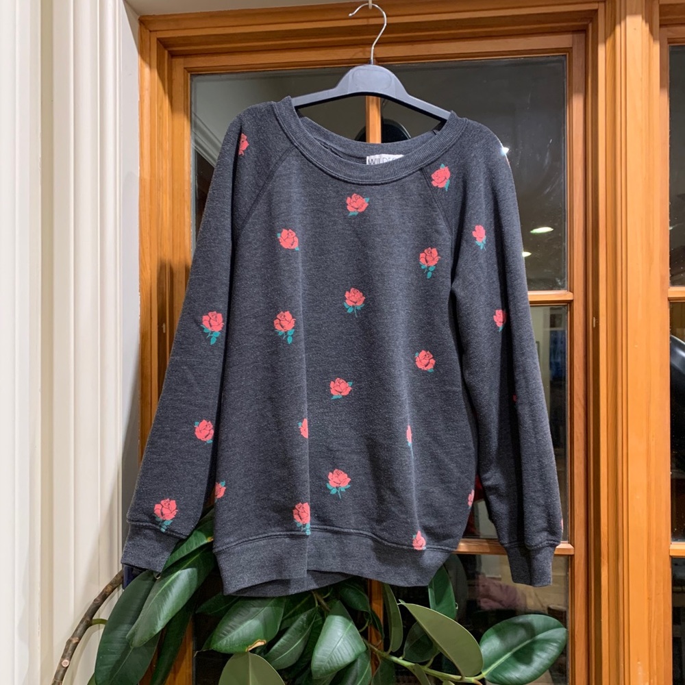 Wildfox black sweater with roses in a women’s M.